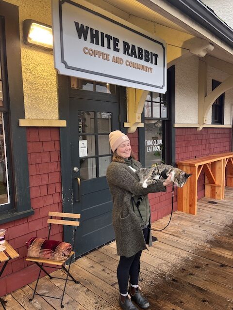 mom holding Zero up infront of th eWhite Rabbit Coffee co.
