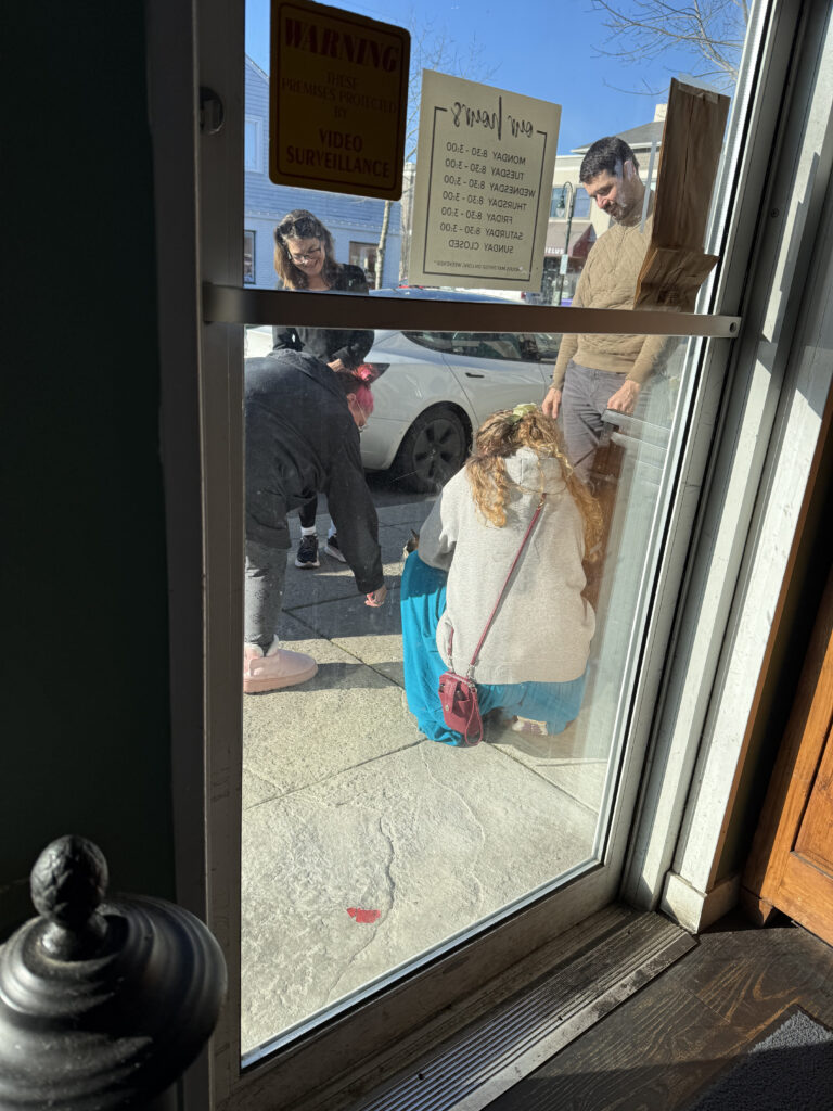 Zero being greeted by fans outside the cafe