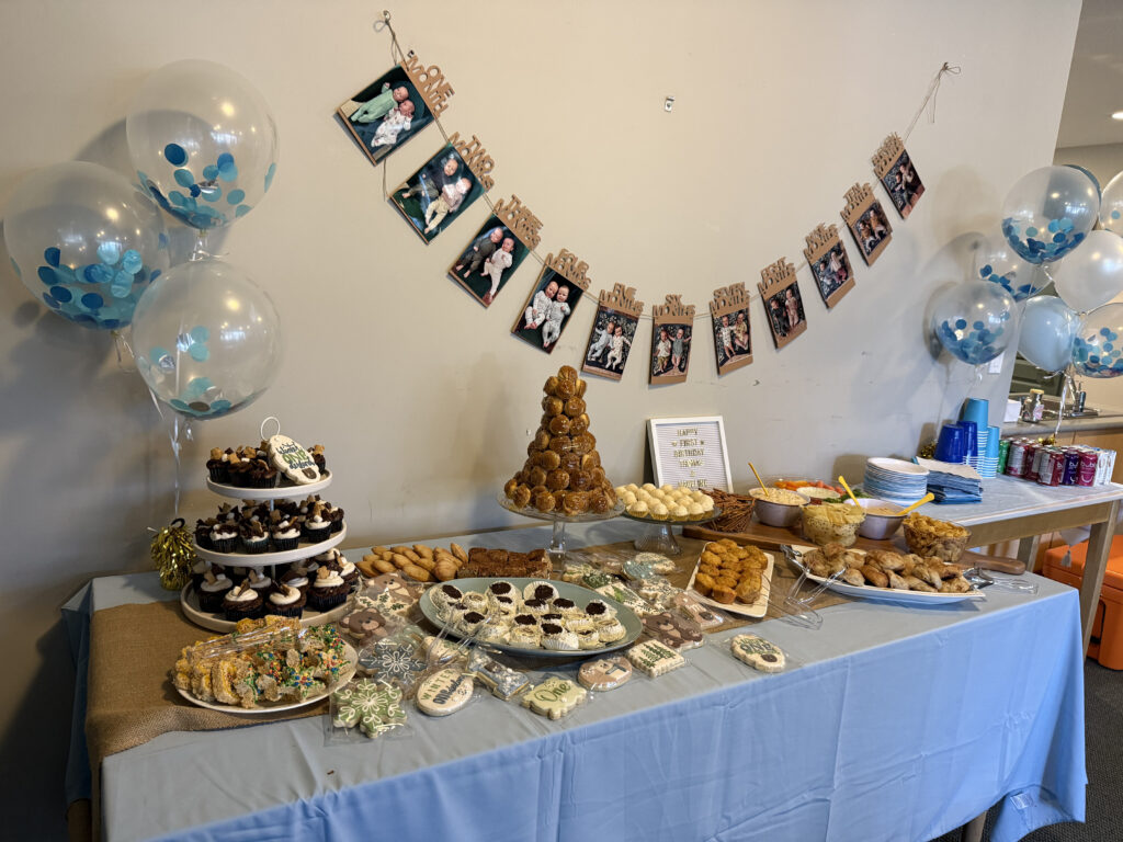 A table of decorations and sweet treats from baby birthday